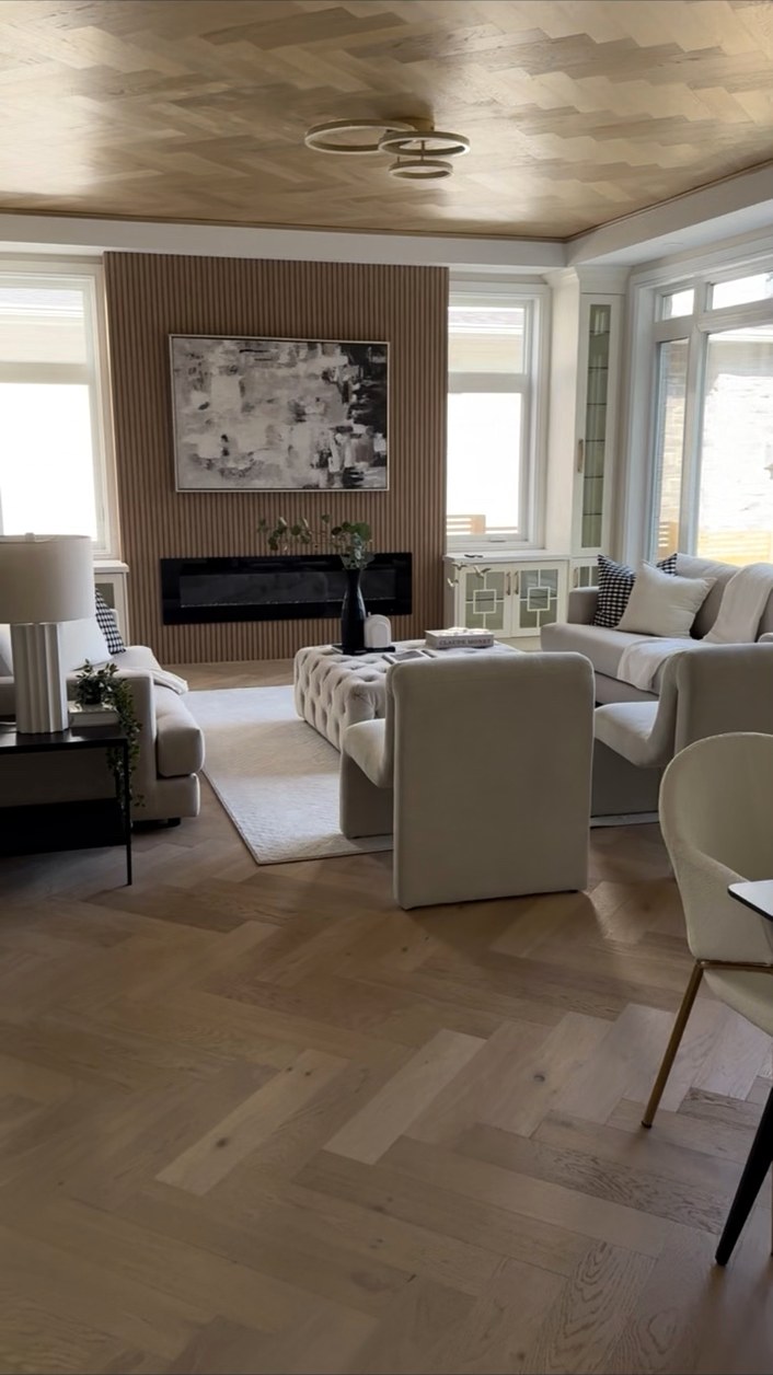 Living room with herringbone wood flooring and a wood ceiling