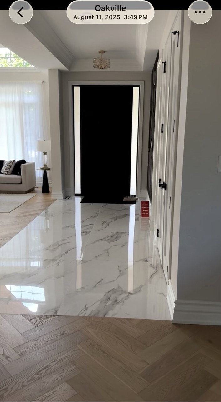 White stone entryway meeting wood flooring